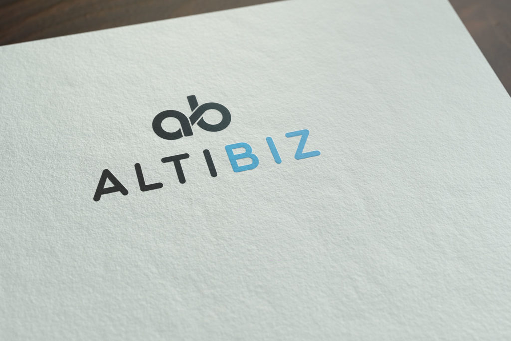 Logo Design for the company Altibiz. Simple logo in blue and gray in just the way our clients wanted. The logo is on the white page of the paper. The logo icon is a monogram in a dark color. Below it is the company name in printed letters, alti in dark color, and BIZ in bright, but lighter blue.