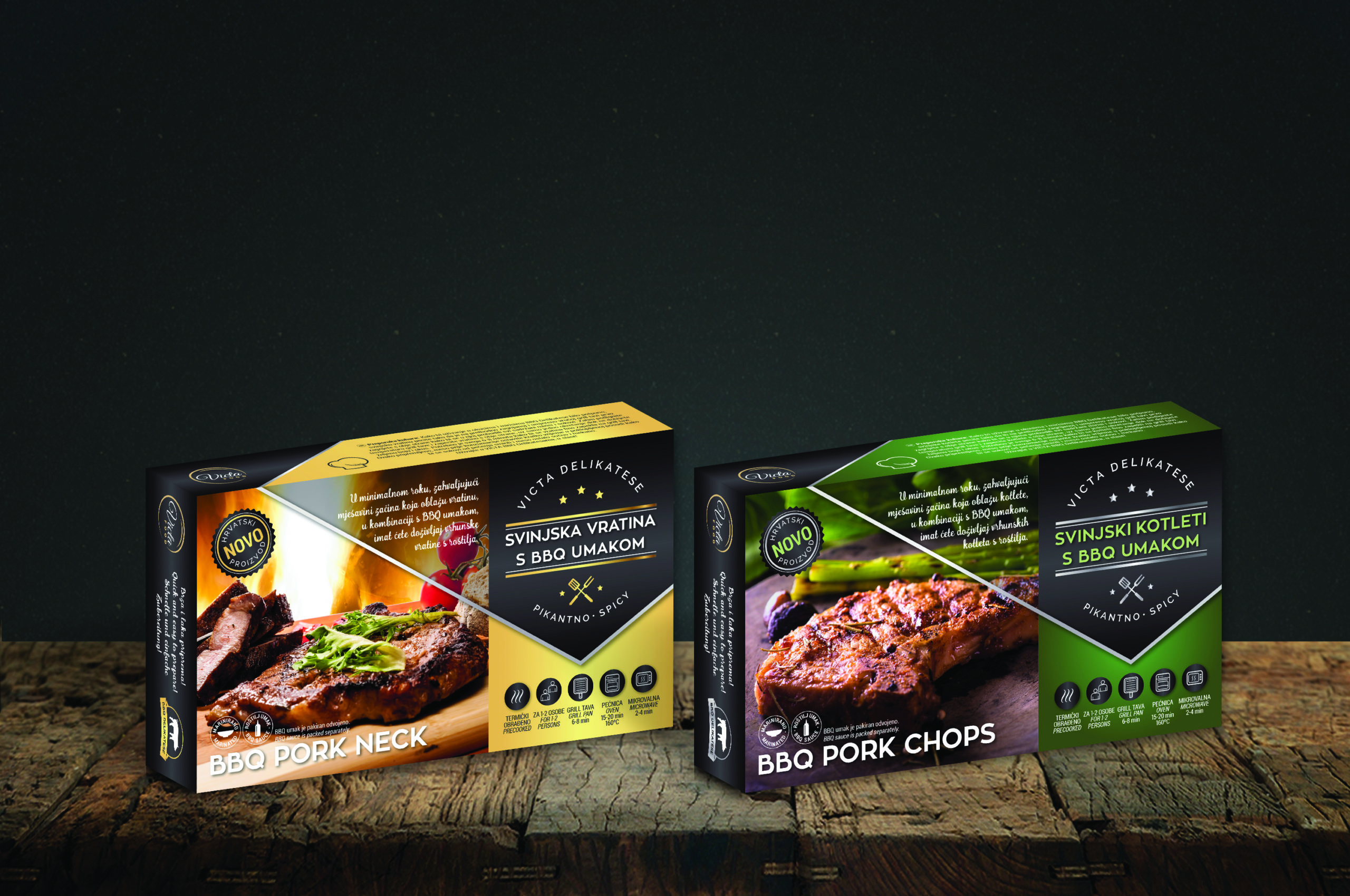 The picture shows two packages of Victa food products. One package is yellow BBQ Pork Neck, the other is green BBQ Pork Chops. The products are placed on a wooden base, and the background is dark gray