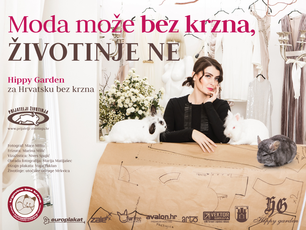 Campaign for Animal Friends Croatia with fashion designer Hippy Garden as spokesperson. In the picture we see Đurđica Vorkapić, the fashion designer behind the Hippy Garden brand, sitting at her desk. There are fashion sketches on the table. On each side of her is a rabbit on the table. One is completely white, the other is white with black ears. Behind her is a fashion studio with a model, clothes and flowers all in white. Đurđica wore a black top. At the top of the billboard is the slogan of the campaign 