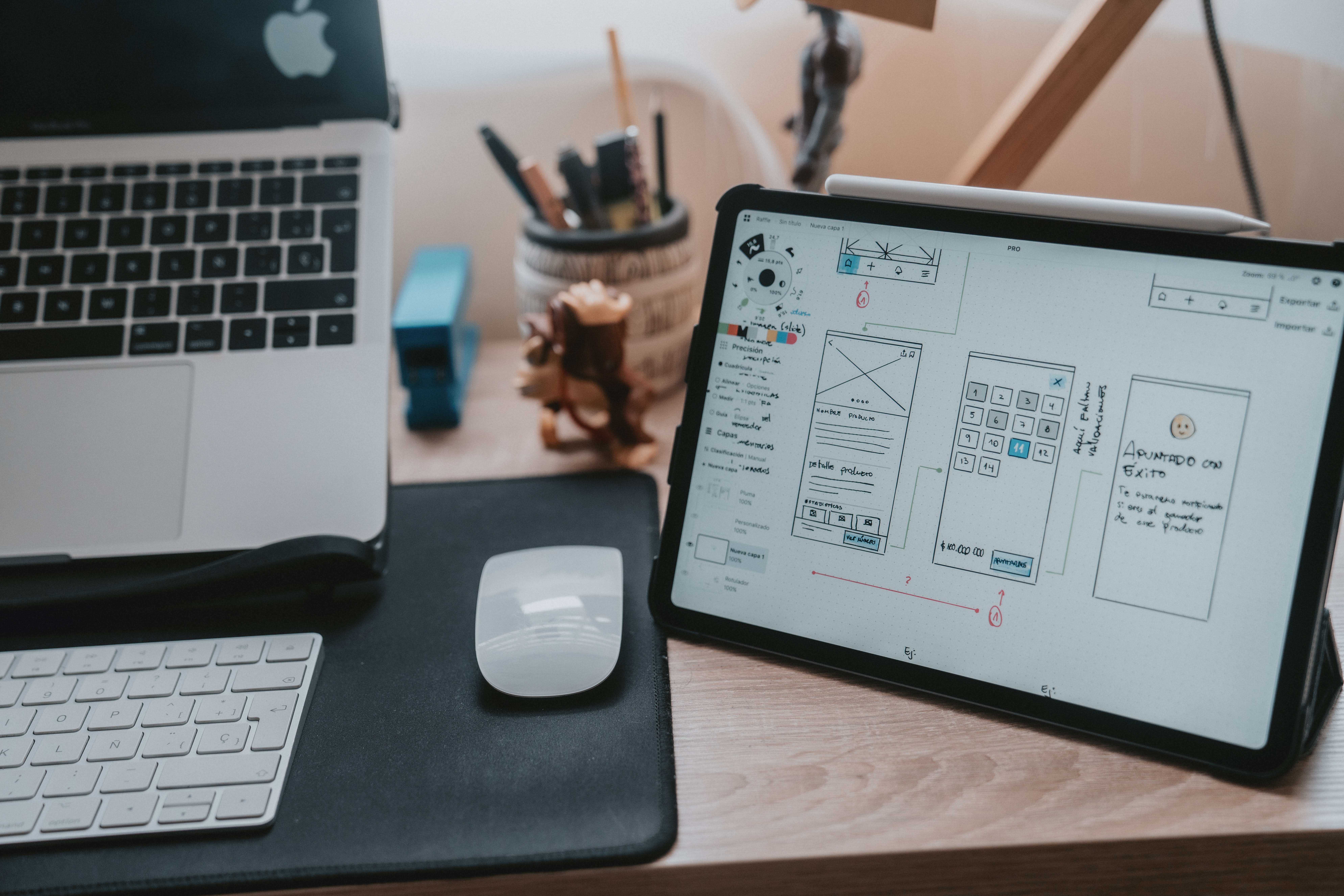 Blog about UX and UI design: In the picture we see a desk with a monitor and a tablet in the process of creating UX design