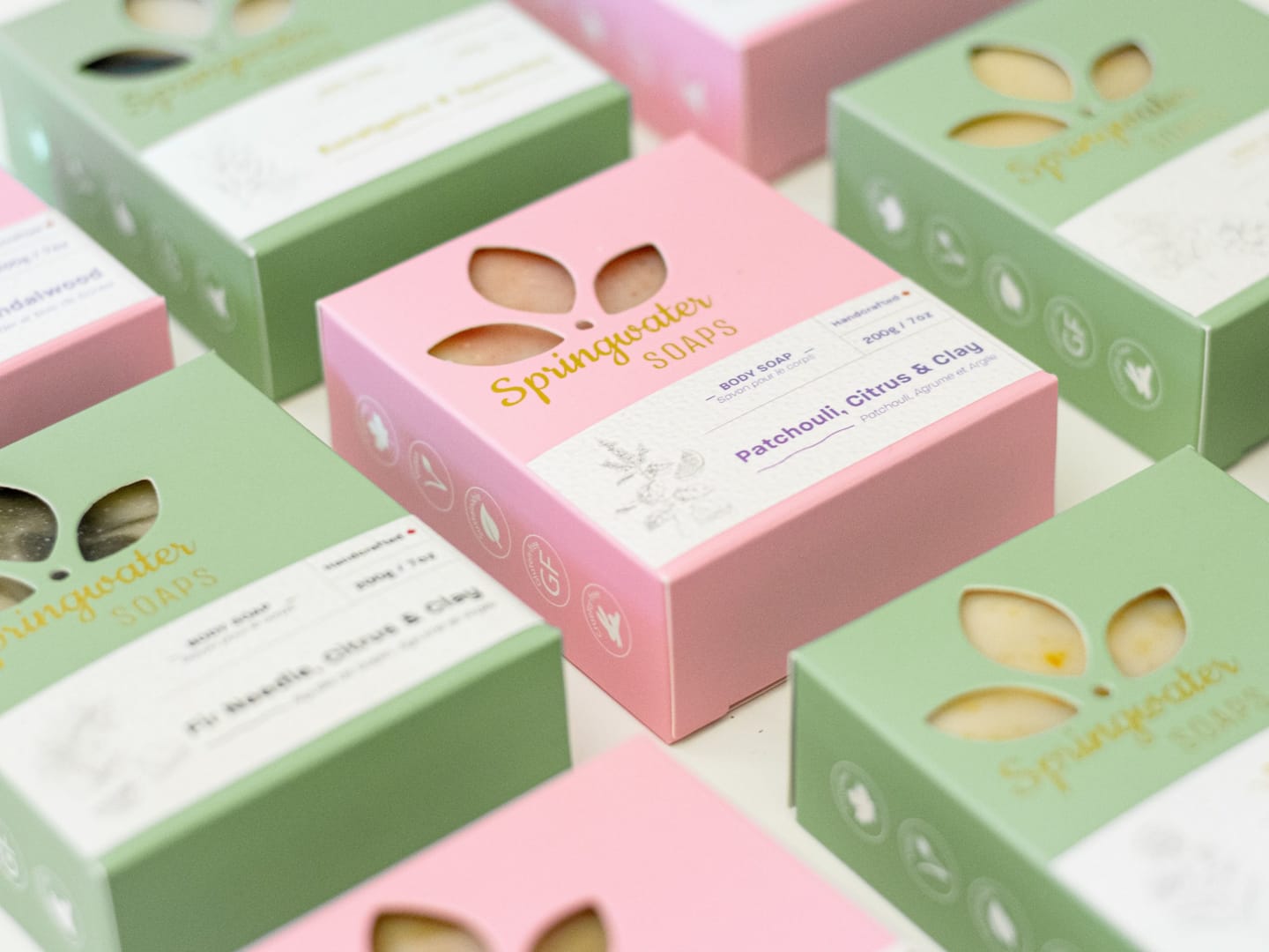 Pink and green Springwater Soaps boxes with leaf-shaped cut-out windows