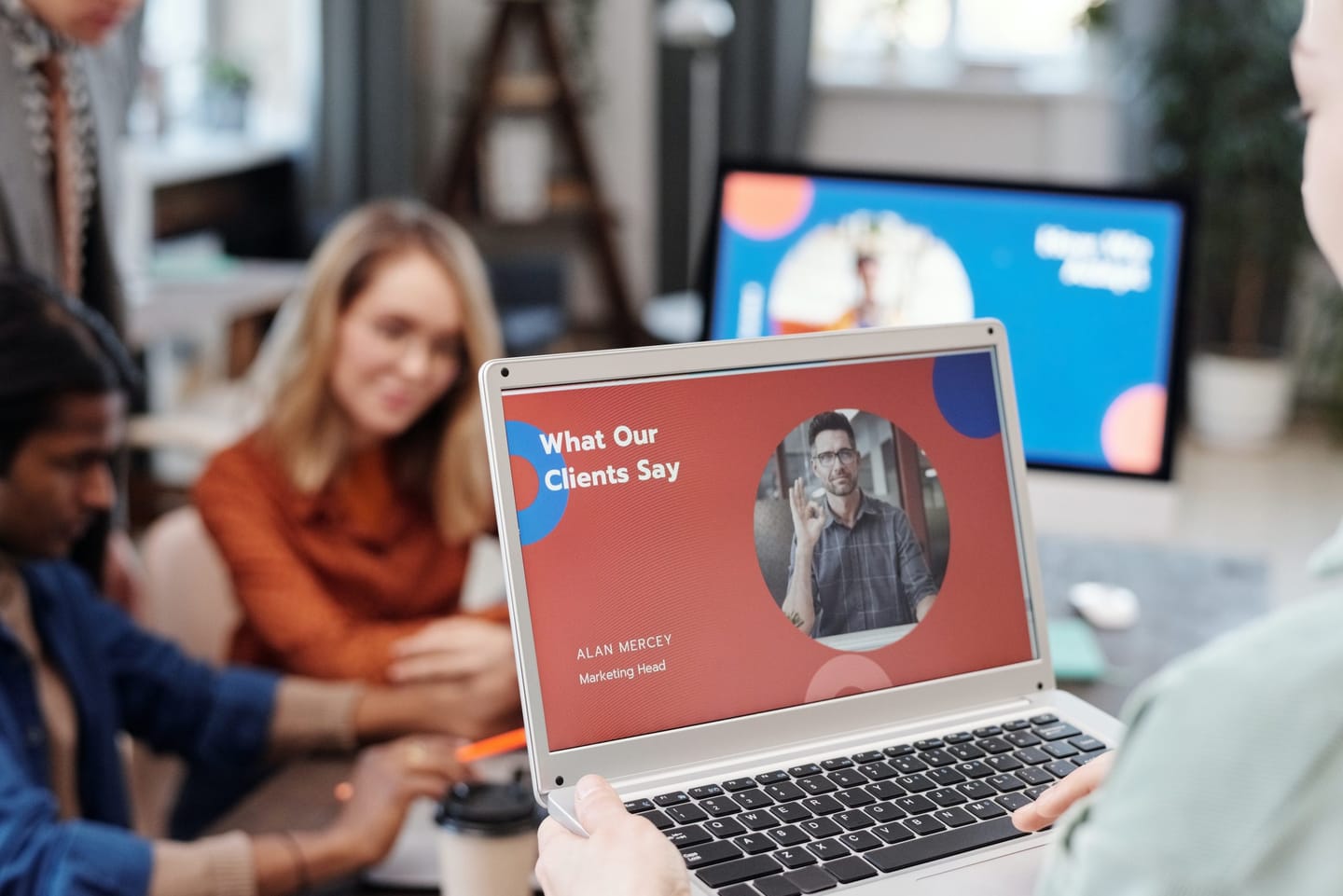 Digital Marketing blog: the picture shows an office with people and a laptop with a marketing message on the screen.