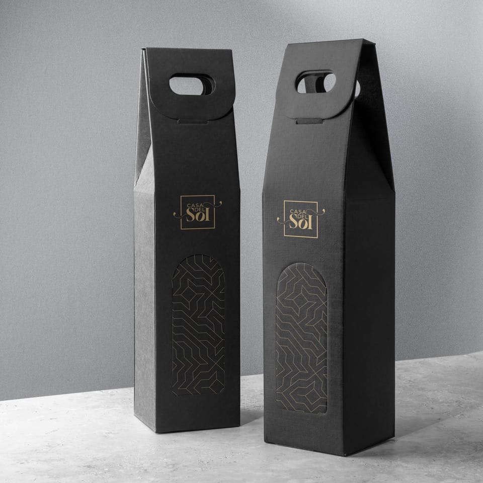 Two black Casa del Sol wine boxes with a gold logo and a geometric pattern