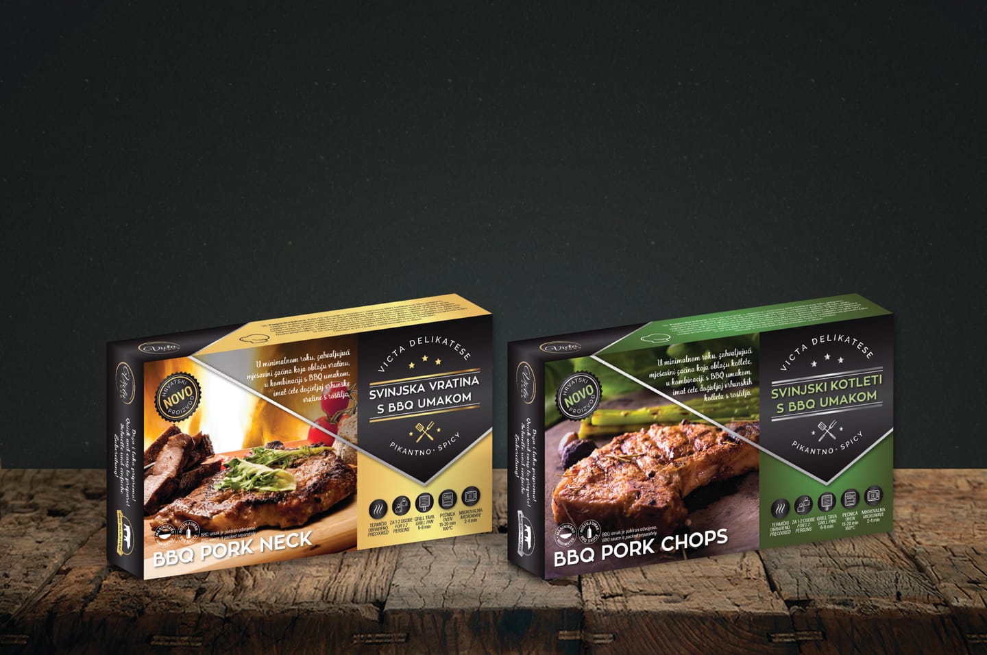 Two Victa Food packs, the yellow BBQ Pork Neck and the green BBQ Pork Chops, on a wooden surface against a dark grey background