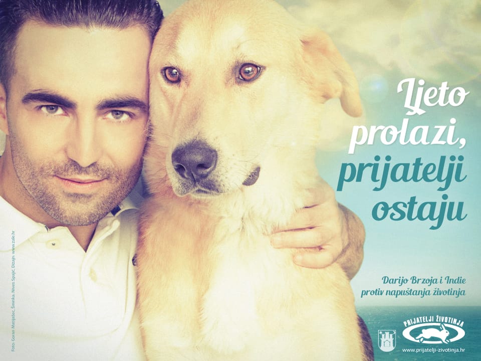 Animal Friends Croatia billboard against animal abandonment: Darijo Brzoja hugging a light yellow dog, with the slogan “Ljeto prolazi, prijatelji ostaju” (Summer passes, friends remain)