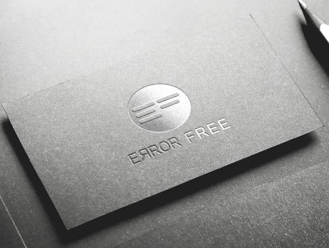 Grey business card with the Error Free logo in relief