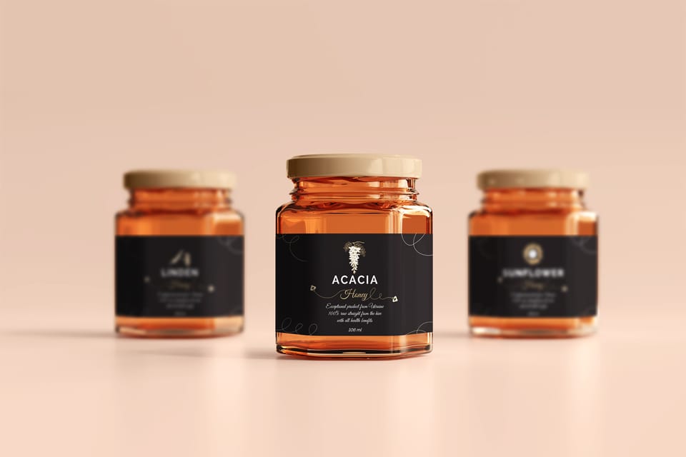 Shevchenko honey labels: three jars with black labels, acacia honey in front